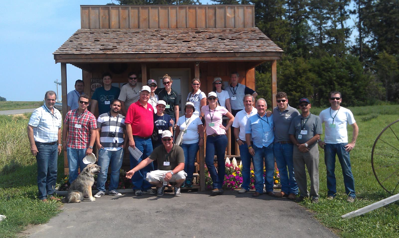 A tour group standing in front of the Country Cupboard farm store
